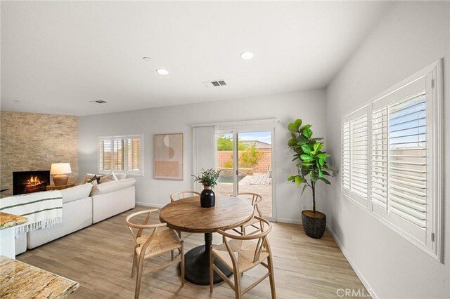 73992 Van Gogh Dr, Palm Desert, CA 92211 - dining area featuring healthy amount of natural light, light wood finished floors, a fireplace, baseboards, and recessed lighting