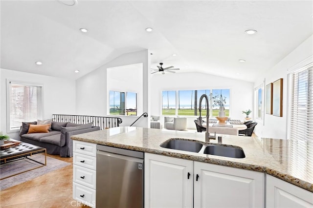 kitchen featuring vaulted ceiling, dishwasher, a sink, open floor plan, and ceiling fan