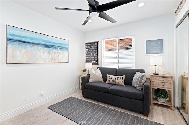 living room with recessed lighting, light wood-style floors, baseboards, and a ceiling fan