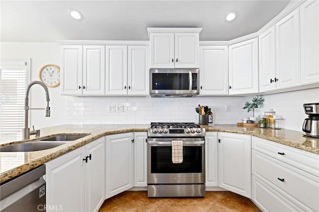 916 E Oceanfront, Newport Beach, CA 92661 - kitchen with stainless steel appliances, white cabinetry, backsplash, and recessed lighting