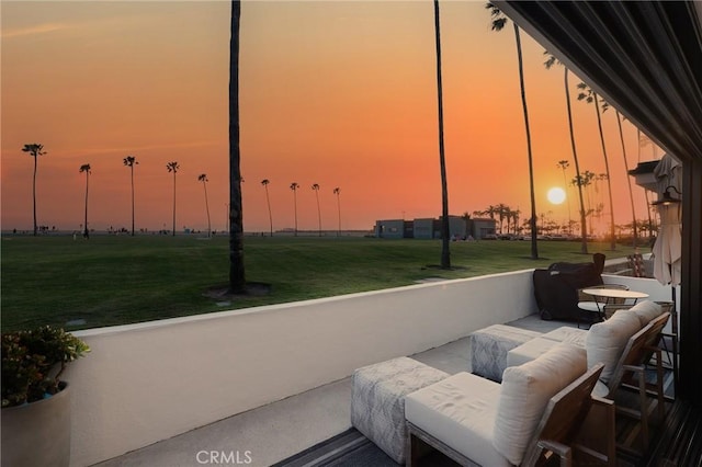916 E Oceanfront, Newport Beach, CA 92661 - patio terrace at dusk featuring a grill and a lawn