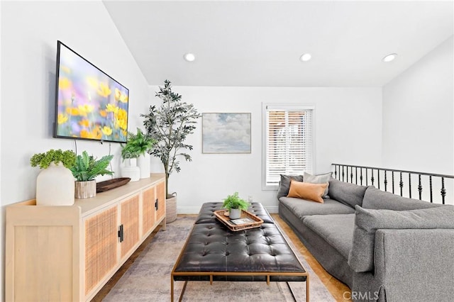 living area with baseboards, vaulted ceiling, and recessed lighting