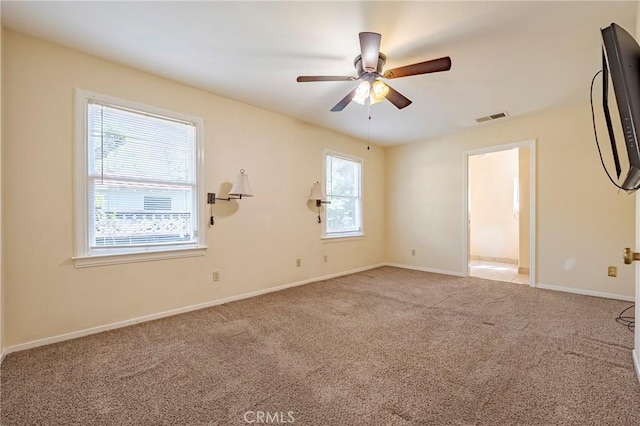 2550 5th Ave, Merced, CA 95340 - carpeted spare room featuring plenty of natural light, visible vents, baseboards, and a ceiling fan
