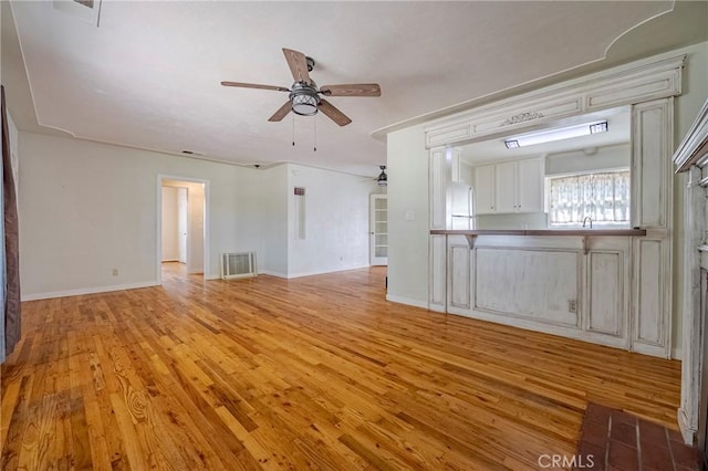 2550 5th Ave, Merced, CA 95340 - unfurnished living room featuring ceiling fan and light wood-style floors