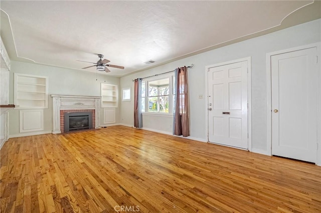 2550 5th Ave, Merced, CA 95340 - unfurnished living room featuring light wood-style floors, ceiling fan, built in features, and a fireplace