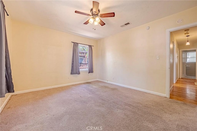 2550 5th Ave, Merced, CA 95340 - carpeted empty room featuring plenty of natural light, a ceiling fan, and a smoke detector