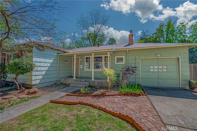 2550 5th Ave, Merced, CA 95340 - single story home featuring concrete driveway, a chimney, a garage, and covered porch