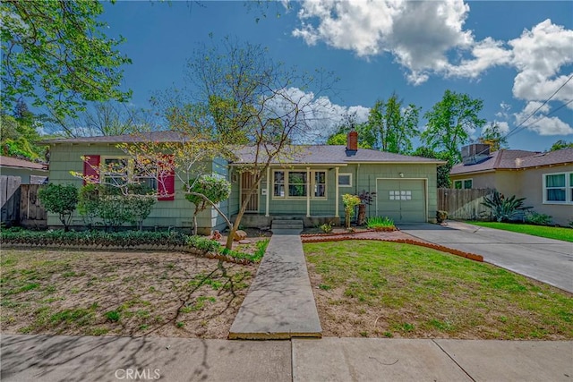 2550 5th Ave, Merced, CA 95340 - single story home featuring a front yard, fence, an attached garage, a chimney, and concrete driveway