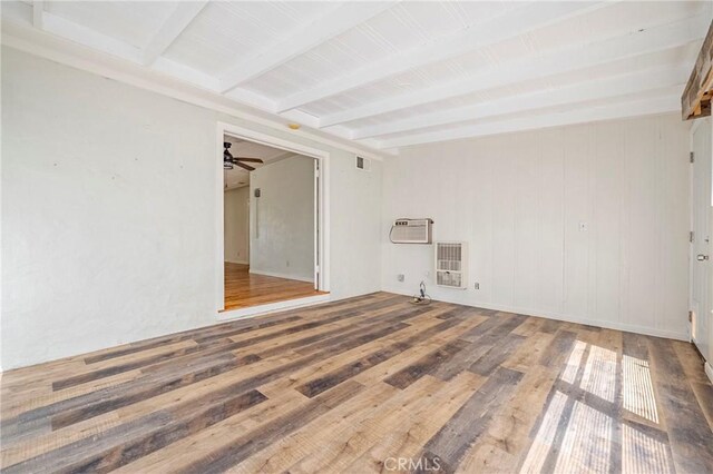2550 5th Ave, Merced, CA 95340 - unfurnished room with beamed ceiling, wood finished floors, heating unit, a wall mounted AC, and a ceiling fan