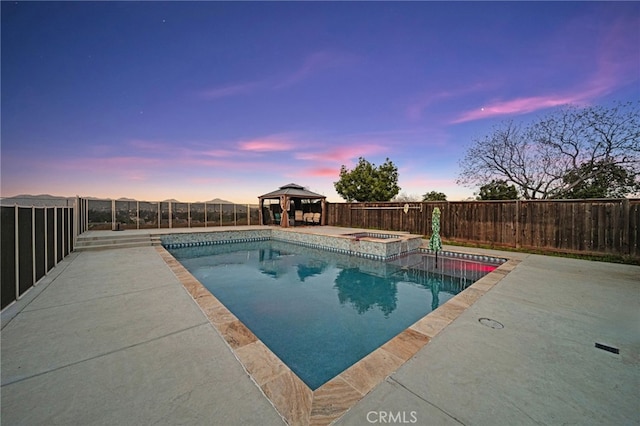pool at dusk with a fenced backyard, a patio, a gazebo, and a pool with connected hot tub