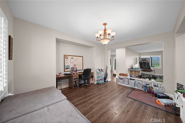 office space with baseboards, wood finished floors, and a notable chandelier