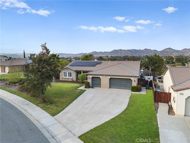 single story home with a garage, a mountain view, and driveway