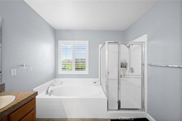 full bathroom with vanity, a shower stall, and a garden tub