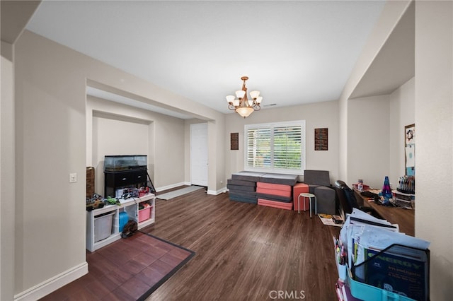 interior space with an inviting chandelier, baseboards, and wood finished floors