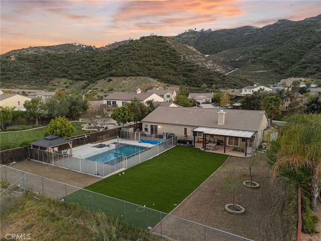 20536 Black Walnut Ct, Wildomar, CA 92595 - pool at dusk featuring a patio area, a mountain view, and a residential view