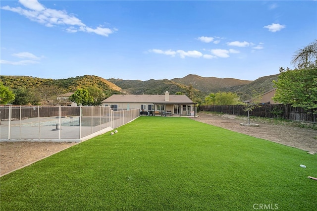 view of yard with a fenced in pool, a fenced backyard, a patio area, and a mountain view