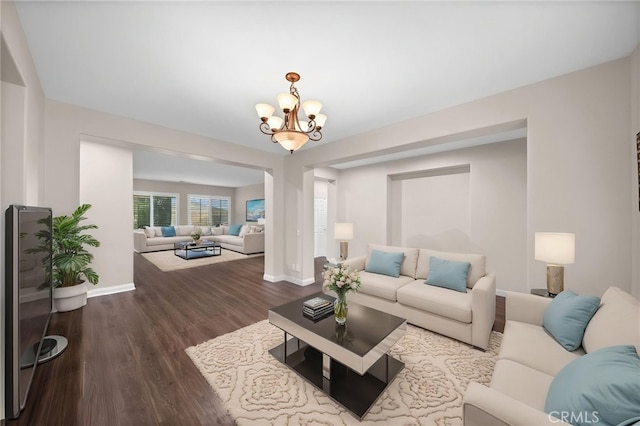 20536 Black Walnut Ct, Wildomar, CA 92595 - living room featuring a chandelier, dark wood-style flooring, and baseboards