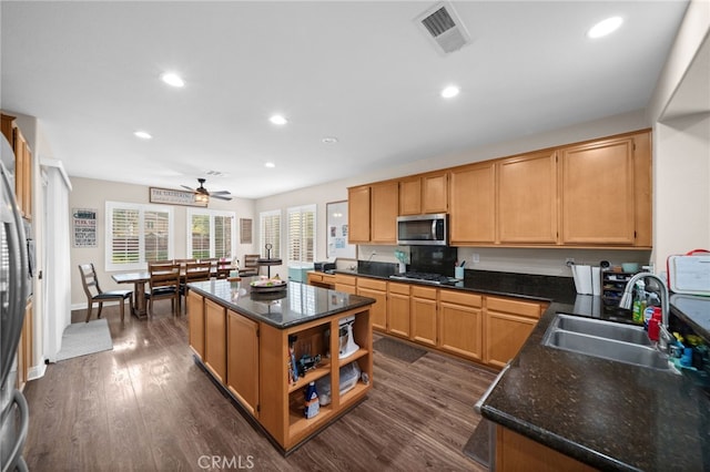 kitchen featuring visible vents, a kitchen island, recessed lighting, a sink, and stainless steel appliances