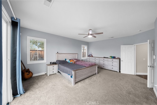 bedroom featuring a ceiling fan, baseboards, visible vents, and carpet