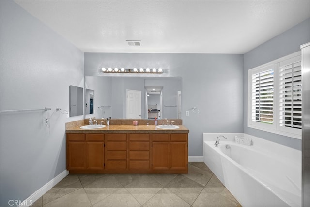 full bath with double vanity, a sink, baseboards, and a bath