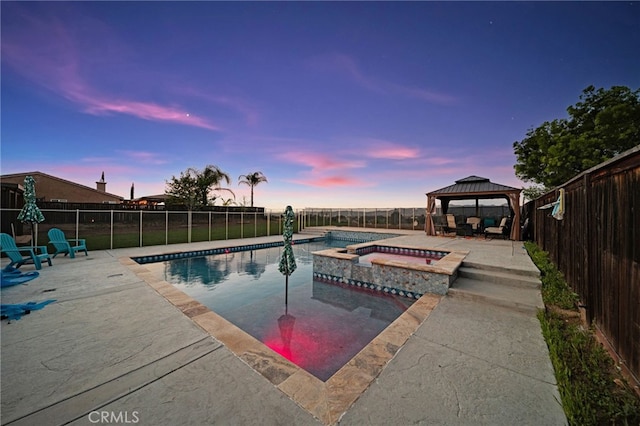 20536 Black Walnut Ct, Wildomar, CA 92595 - pool at dusk featuring a gazebo, a patio, a fenced backyard, and a pool with connected hot tub