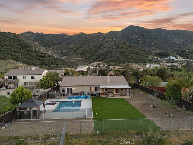 view of pool featuring a yard, a patio, a fenced in pool, and a fenced backyard