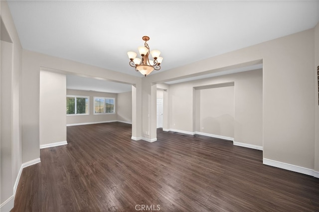 20536 Black Walnut Ct, Wildomar, CA 92595 - unfurnished room featuring dark wood-type flooring, a chandelier, and baseboards