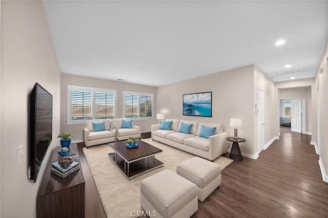 living room with visible vents, recessed lighting, baseboards, and wood finished floors