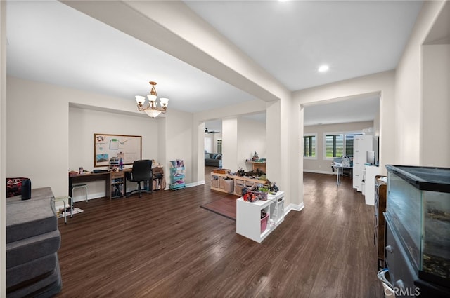 living area featuring recessed lighting, baseboards, an inviting chandelier, and dark wood-type flooring