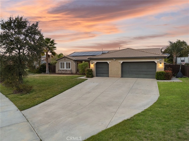 20536 Black Walnut Ct, Wildomar, CA 92595 - view of front of house featuring driveway, stucco siding, a garage, a tile roof, and roof mounted solar panels