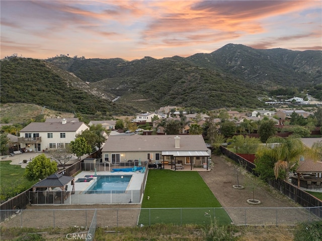 view of pool featuring a fenced in pool, a residential view, a fenced backyard, and a patio area