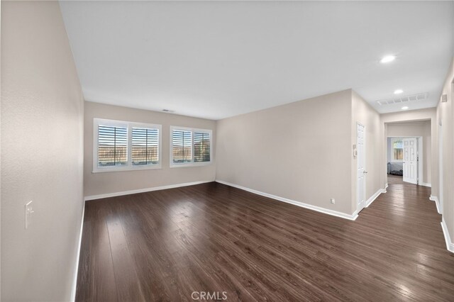 unfurnished living room featuring recessed lighting, baseboards, visible vents, and dark wood finished floors
