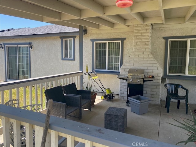view of patio with a wooden deck and a grill