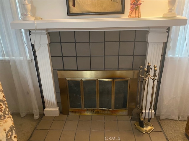 interior details with a brick fireplace