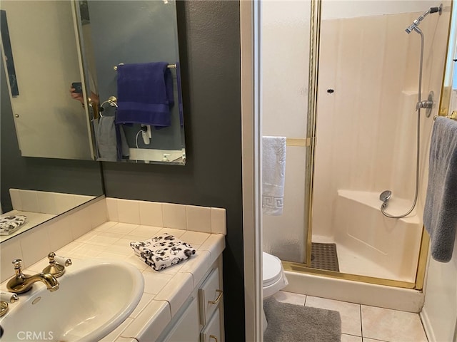 bathroom featuring vanity, tile patterned flooring, a shower stall, and toilet
