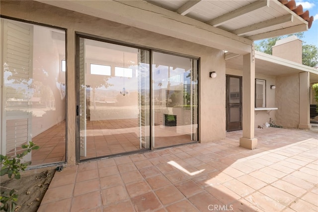 263 Serena Dr, Palm Desert, CA 92260 - property entrance with stucco siding, a patio, and a chimney