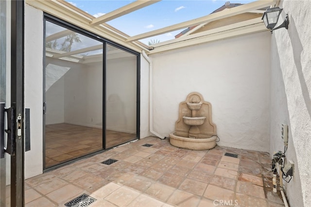 unfurnished sunroom with a skylight