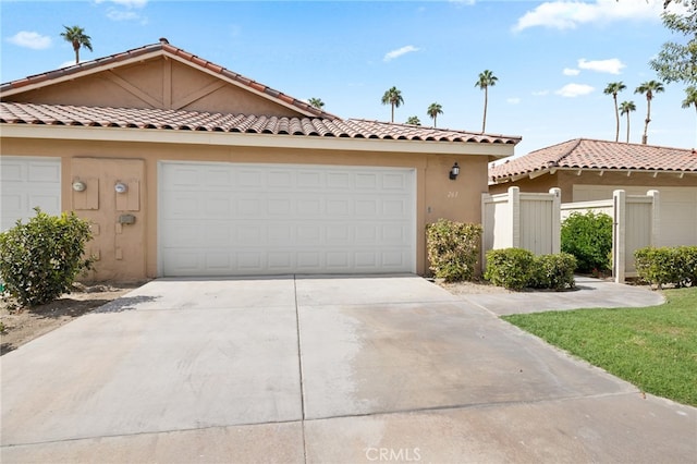 263 Serena Dr, Palm Desert, CA 92260 - view of front of house featuring concrete driveway, stucco siding, fence, and an attached garage