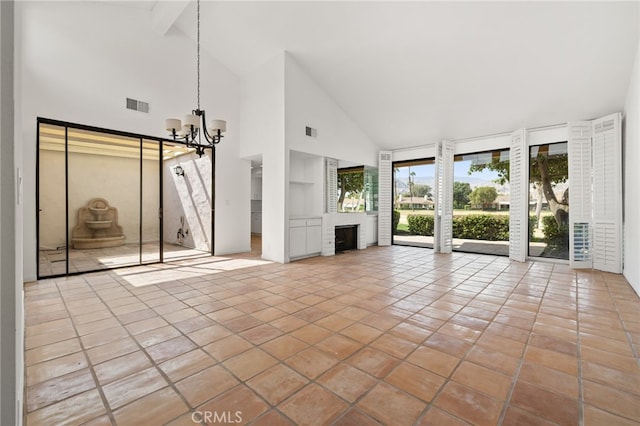 unfurnished living room featuring high vaulted ceiling, a chandelier, built in features, tile patterned flooring, and a brick fireplace