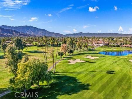 view of home's community with a water and mountain view and view of golf course