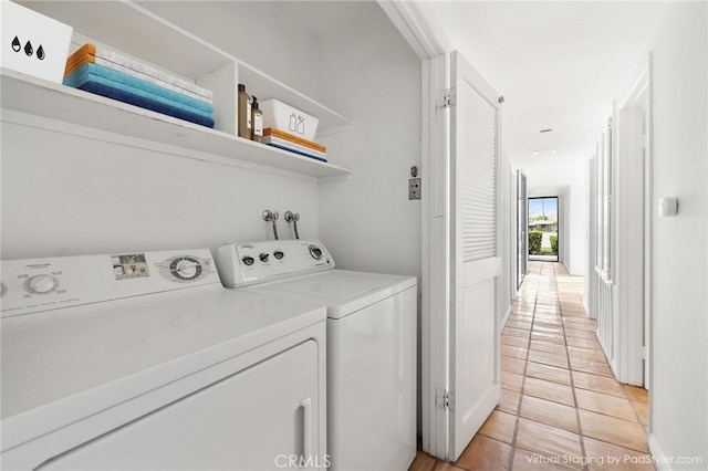 clothes washing area with separate washer and dryer and light tile patterned floors