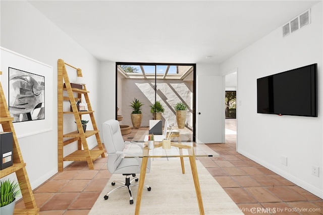 dining area featuring light tile patterned floors and baseboards