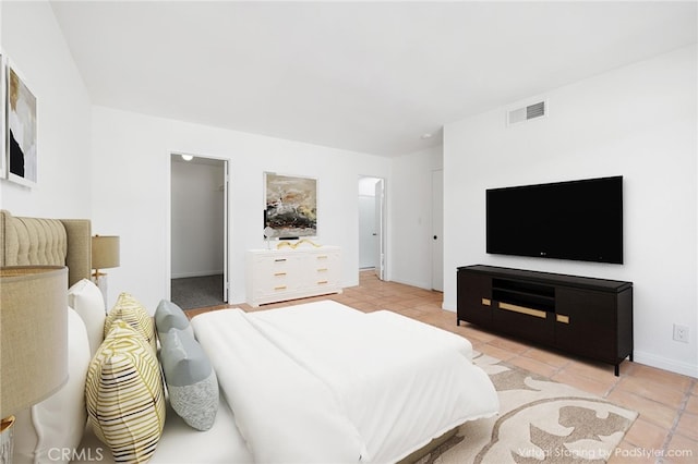 bedroom featuring light tile patterned floors and baseboards