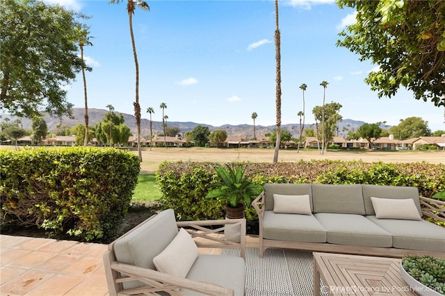 view of patio featuring an outdoor living space and a mountain view