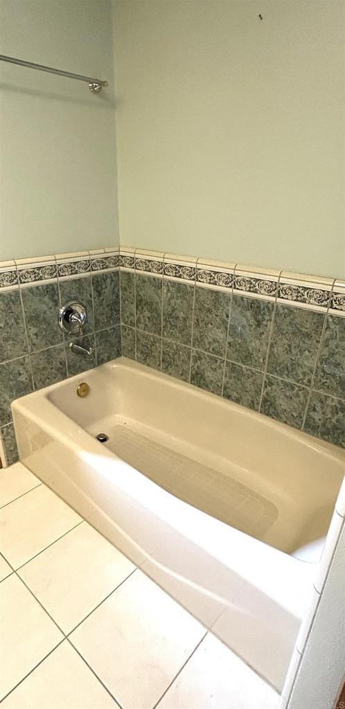 full bathroom featuring tile patterned flooring and a bath