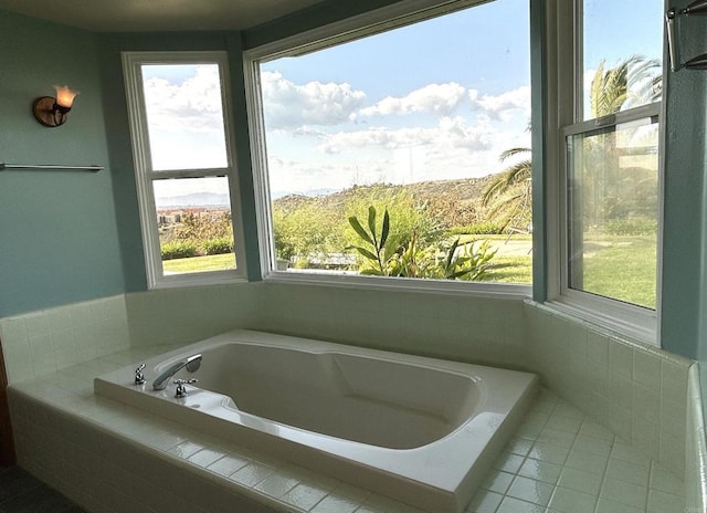 bathroom with a bath and tile patterned floors