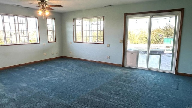 carpeted empty room with baseboards and ceiling fan