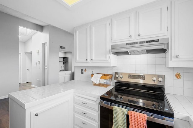 5170 Clairemont Mesa Blvd Unit 27, San Diego, CA 92117 - kitchen with stainless steel electric stove, under cabinet range hood, tile countertops, and white cabinets