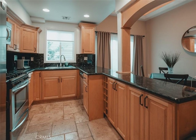 1153 San Rafael Ave Unit 105, Glendale, CA 91202 - kitchen featuring a sink, backsplash, a peninsula, and stainless steel appliances