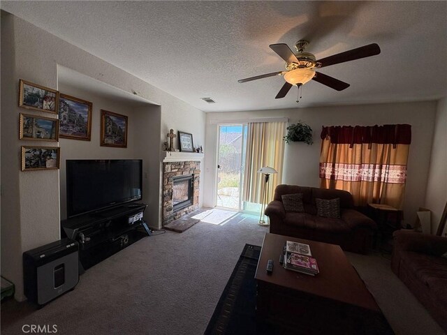3324 Rosegold Ave, Rosamond, CA 93560 - living area featuring ceiling fan, a fireplace, carpet floors, a textured ceiling, and visible vents